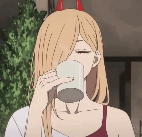 A Girl With Horns On Her Head Drinks From A Cup GIF