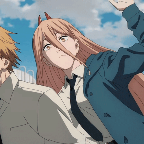 A Girl With Horns On Her Head Is Standing Next To A Man In A Suit GIF
