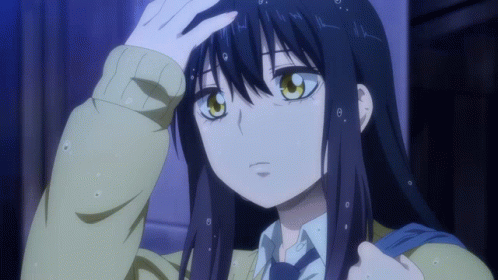A Girl With Long Black Hair And Yellow Eyes Is Holding Her Hand To Her Forehead GIF