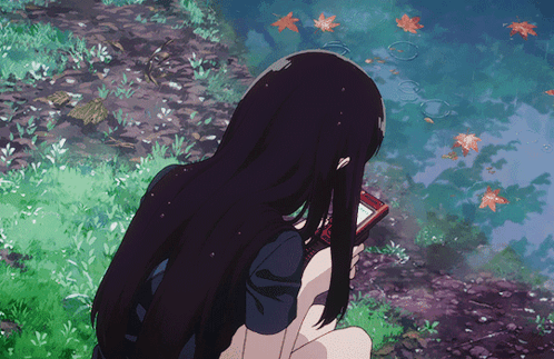 A Girl With Long Black Hair Is Holding A Cell Phone In Her Hand GIF