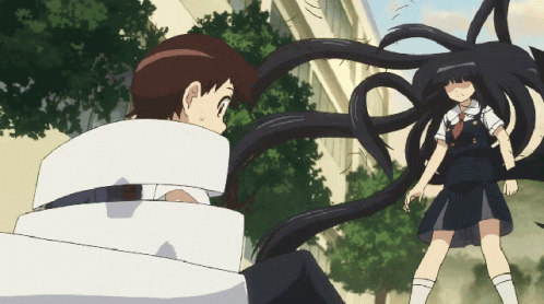 A Girl With Long Black Hair Is Standing Next To A Boy Who Is Wrapped In White Tape GIF