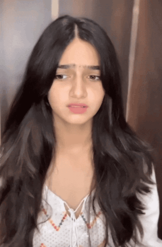 A Girl With Long Black Hair Is Wearing A White Shirt GIF