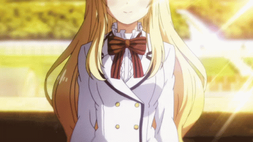 A Girl With Long Blonde Hair Is Wearing A White Jacket And A Bow Tie GIF