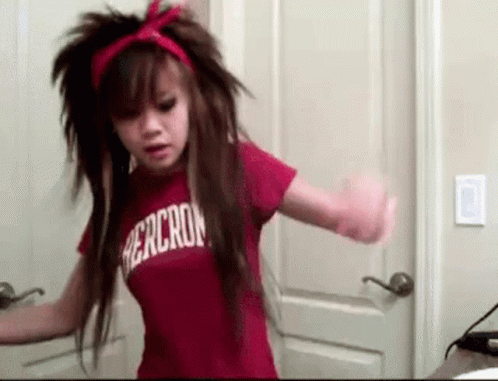 A Girl With Long Hair Is Wearing A Red Shirt That Says Abercrombie . GIF