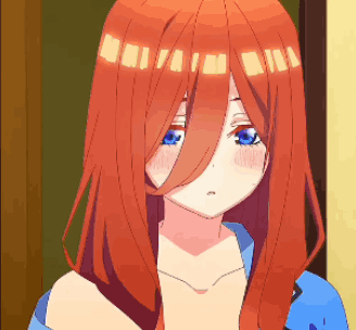 A Girl With Long Red Hair And Blue Eyes Is Standing In Front Of A Door . GIF