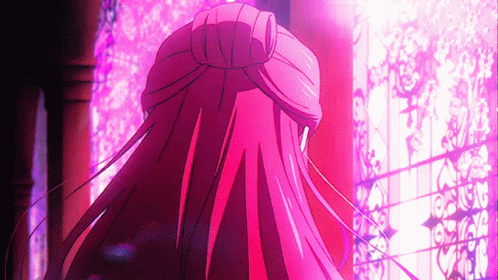 A Girl With Long Red Hair Is Standing In Front Of A Window GIF