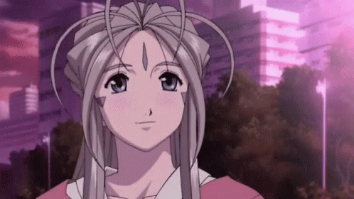 A Girl With Long White Hair And A Crown On Her Head Is Standing In Front Of A Purple Building . GIF