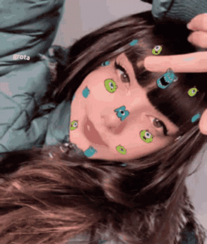 A Girl With Monsters On Her Face Is Being Touched By Someone GIF