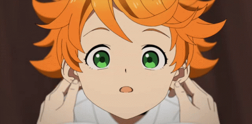 A Girl With Orange Hair And Green Eyes Covering Her Ears With Her Hands GIF