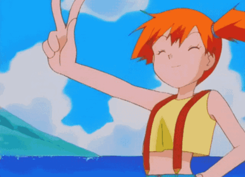 A Girl With Orange Hair Is Giving A Peace Sign In Front Of The Ocean GIF