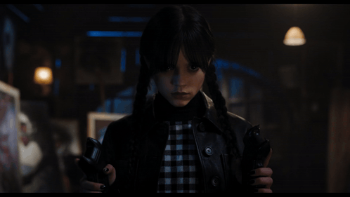 A Girl With Pigtails Is Holding A Gun GIF