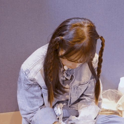 A Girl With Pigtails Is Wearing A Denim Jacket That Says ' Denim ' On The Sleeve GIF