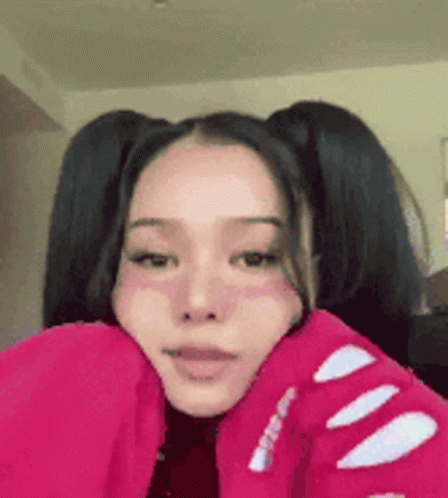 A Girl With Pigtails Is Wearing A Red Jacket And A Red Sweater . GIF