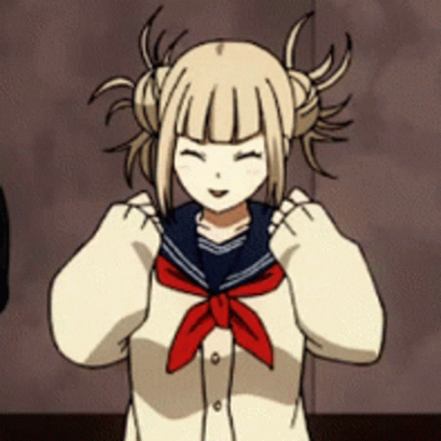 A Girl With Pigtails Is Wearing A Sailor Uniform With A Red Tie Around Her Neck . GIF