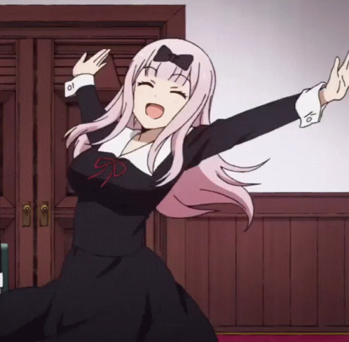 A Girl With Pink Hair And A Bow On Her Head Is Dancing GIF