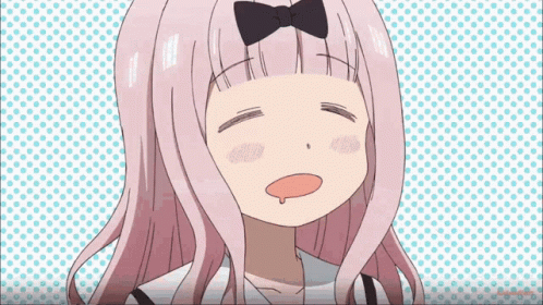 A Girl With Pink Hair And A Bow On Her Head Is Making A Face . GIF