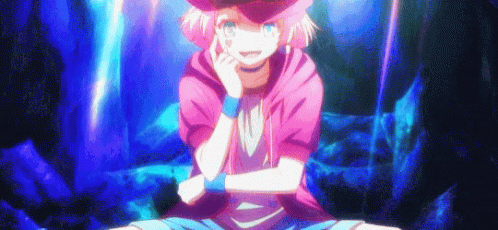 A Girl With Pink Hair And A Hat Is Sitting On The Ground With Her Arms Crossed And Smiling . GIF