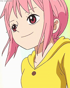 A Girl With Pink Hair And A Yellow Shirt Is Smiling GIF