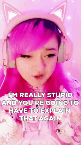 A Girl With Pink Hair And Cat Ears Is Wearing Headphones And Making A Face . GIF