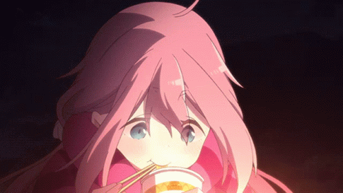A Girl With Pink Hair Is Eating A Cup Of Food With Chopsticks GIF