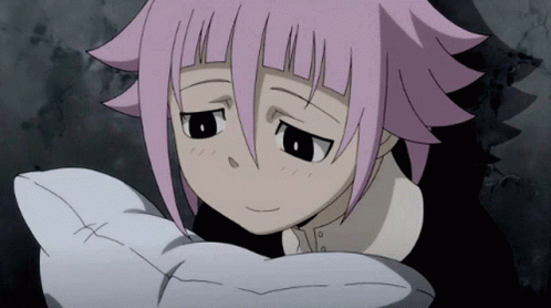 A Girl With Pink Hair Is Holding A White Pillow With A Cross On It GIF