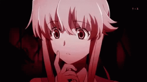 A Girl With Pink Hair Is Holding Her Hand To Her Chin In A Dark Room . GIF