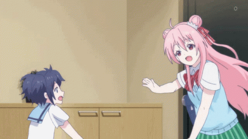 A Girl With Pink Hair Is Hugging Another Girl In A Room GIF