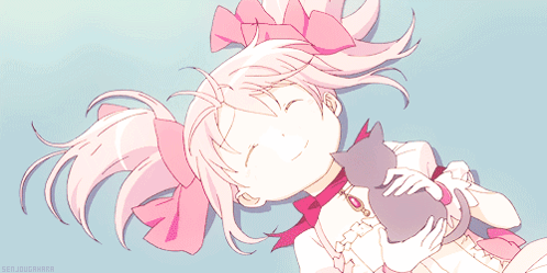 A Girl With Pink Hair Is Laying Down With A Cat GIF