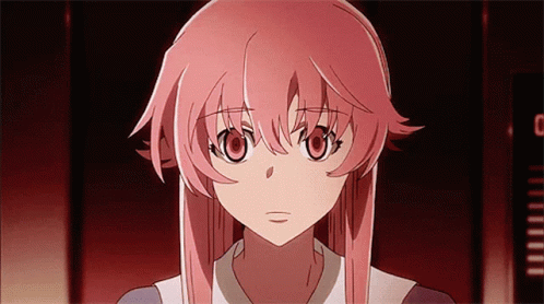 A Girl With Pink Hair Is Looking At The Camera With A Clock In The Background GIF