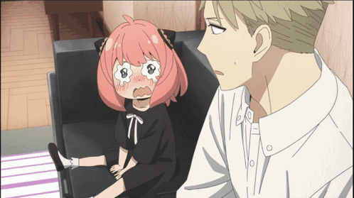 A Girl With Pink Hair Is Sitting On A Couch Next To A Man In A White Shirt GIF