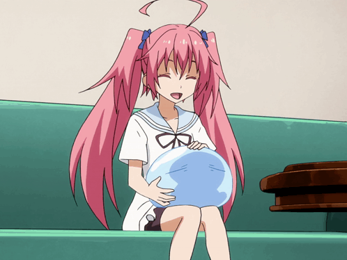A Girl With Pink Hair Is Sitting On A Green Couch GIF