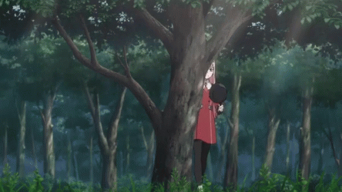 A Girl With Pink Hair Is Standing In The Woods GIF