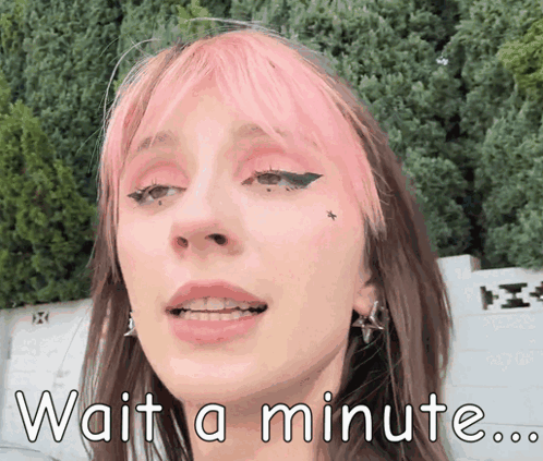 A Girl With Pink Hair Is Waiting For A Minute GIF