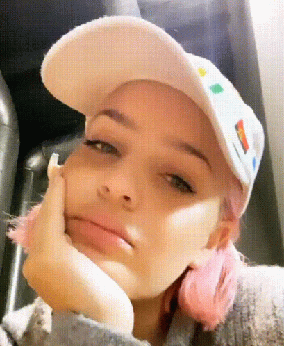 A Girl With Pink Hair Is Wearing A White Hat GIF