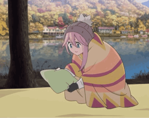 A Girl With Pink Hair Is Wrapped In A Blanket And Reading A Book GIF