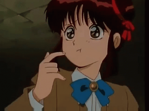 A Girl With Red Hair And A Blue Bow Tie Is Making A Funny Face . GIF