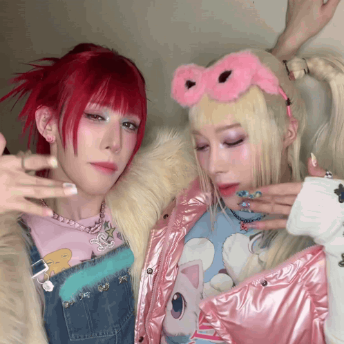 A Girl With Red Hair And A Girl With Blonde Hair Are Posing For A Photo GIF
