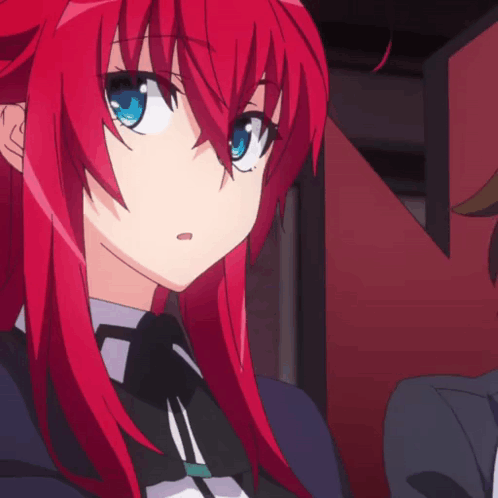 A Girl With Red Hair And Blue Eyes Is Looking At Something GIF