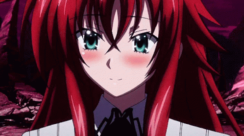 A Girl With Red Hair And Blue Eyes Is Looking At The Camera GIF