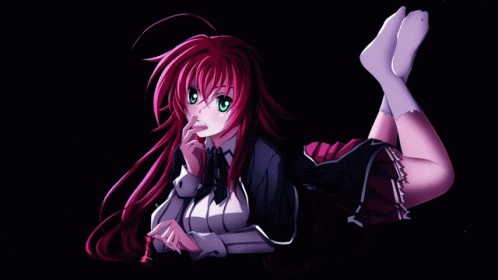 A Girl With Red Hair And Green Eyes Is Laying Down With Her Legs Crossed GIF