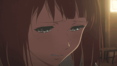 A Girl With Red Hair Is Crying With Her Eyes Closed GIF