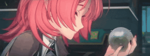 A Girl With Red Hair Is Holding A Clear Ball In Her Hands . GIF