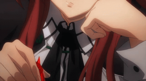 A Girl With Red Hair Is Holding A Red Object In Her Hand GIF