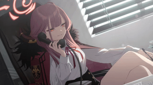A Girl With Red Hair Is Sitting In A Chair Talking On A Telephone GIF