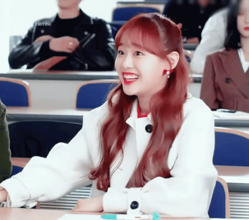 A Girl With Red Hair Is Smiling In A Classroom With Chung Written On The Bottom Left GIF