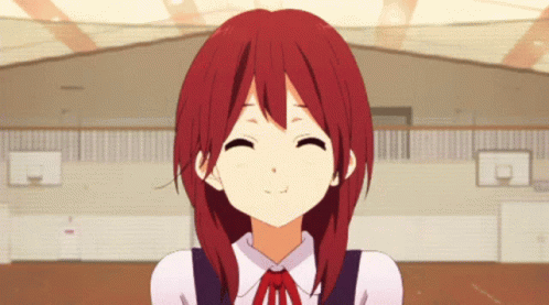 A Girl With Red Hair Is Smiling With A Basketball Court In The Background GIF