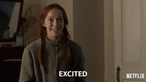 A Girl With Red Hair Is Smiling With The Word Excited Above Her GIF