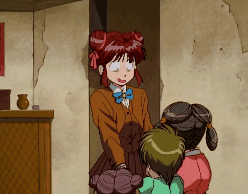 A Girl With Red Hair Is Standing Next To Two Other Girls In A Room GIF