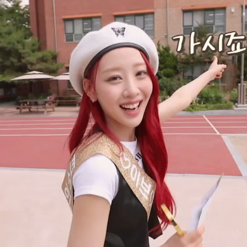 A Girl With Red Hair Is Wearing A White Beret And A Sash That Says ' Eunbi ' On It GIF