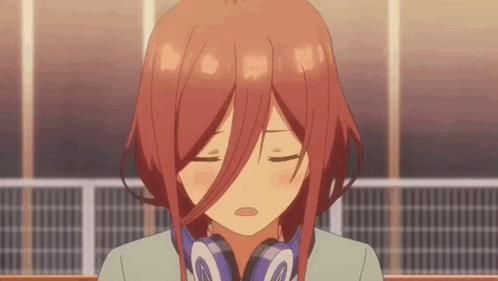 A Girl With Red Hair Is Wearing Headphones And Making A Face . GIF